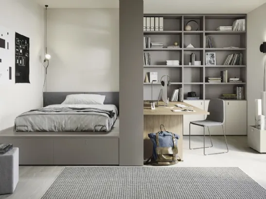 Cameretta con letto su cassettone e ampia libreria Next space 02 di Nidi